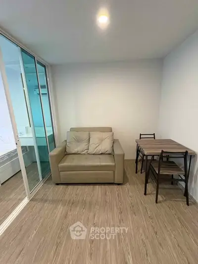 Modern living room with cozy sofa and compact dining set, perfect for urban living.