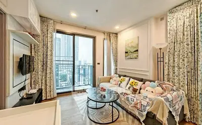Charming living room with cozy decor and city view balcony access.