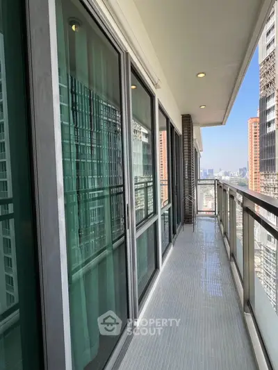 Spacious balcony with city view in modern high-rise apartment