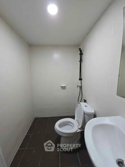 Minimalist bathroom with modern fixtures and white tiles