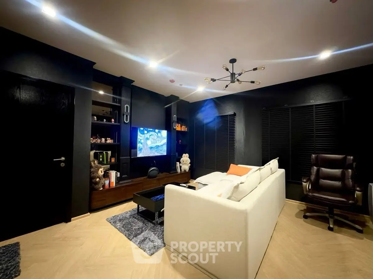 Luxurious modern living room with sleek black accents and cozy white sofa