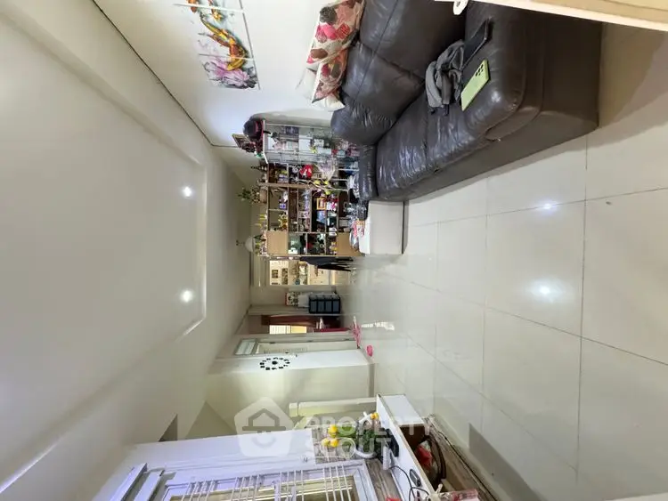 Spacious living room with modern decor and sleek tiled flooring