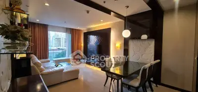 Luxurious living room with modern decor and city view, featuring elegant dining area and stylish lighting.