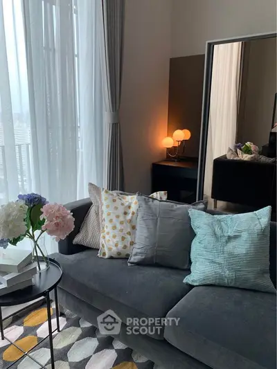 Stylish living room with modern sofa, decorative pillows, and ambient lighting