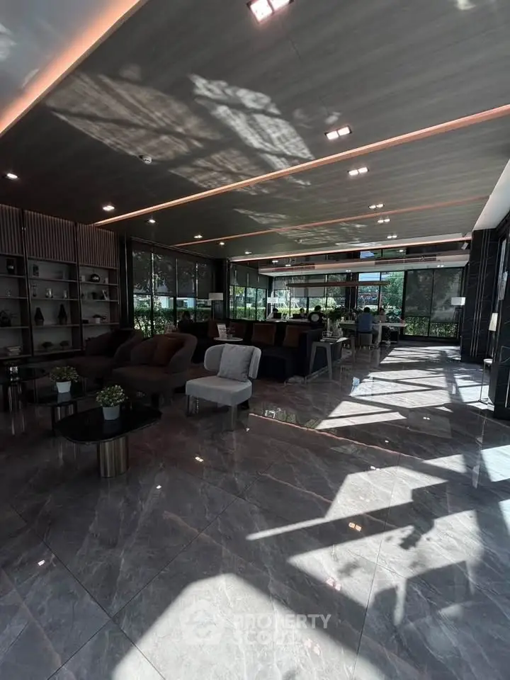 Luxurious modern living room with elegant decor and large windows offering natural light.