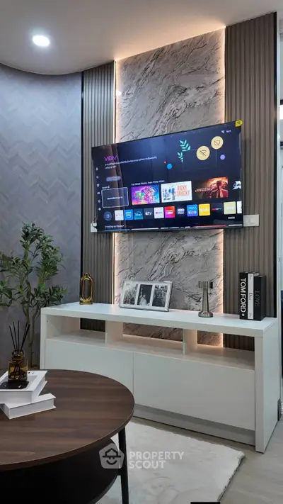 Modern living room with wall-mounted TV and stylish decor