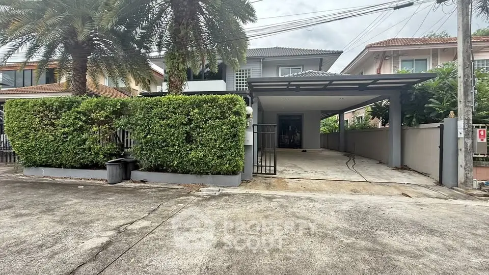 Charming suburban home with spacious driveway and lush greenery, perfect for family living.