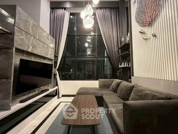 Luxurious living room with high ceilings, modern decor, and stunning city view.