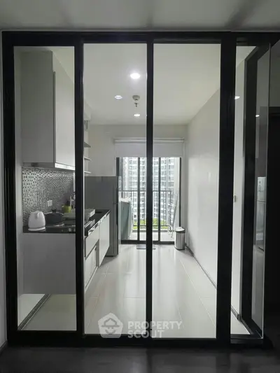 Modern kitchen with sleek design and balcony view in urban apartment