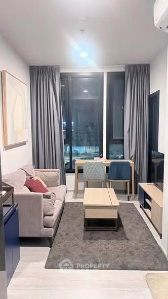 Modern living room with stylish furniture and large windows in a cozy apartment.
