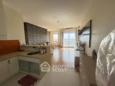 Spacious open-plan living room with kitchen and large windows offering stunning views.
