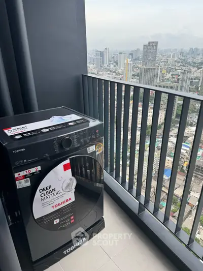 High-rise balcony with city view and modern Toshiba washing machine.