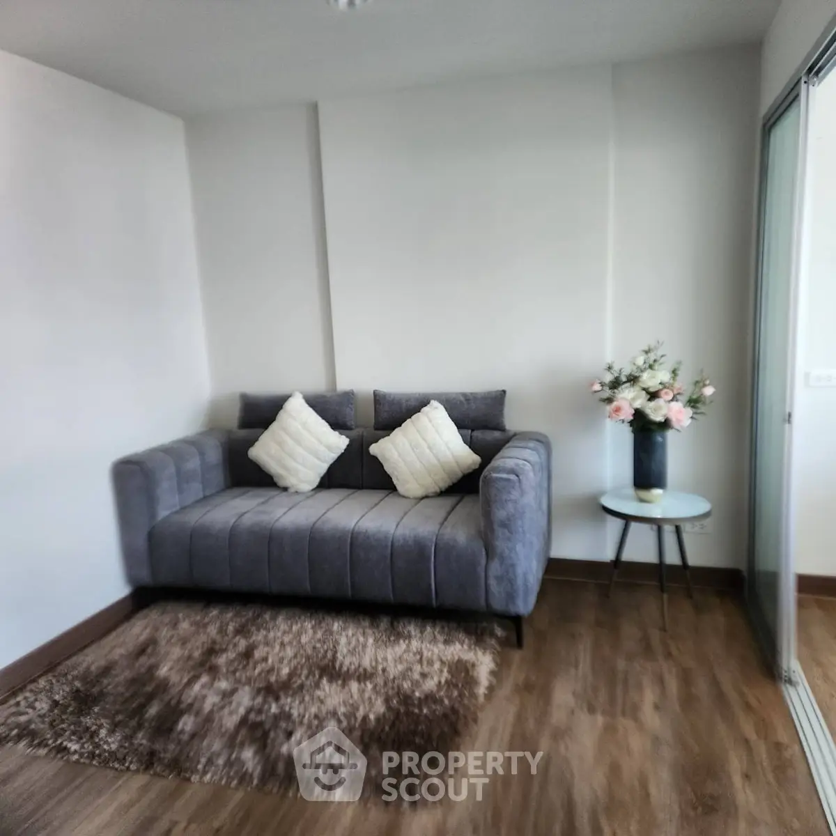 Cozy living room with plush sofa and elegant decor in modern apartment.