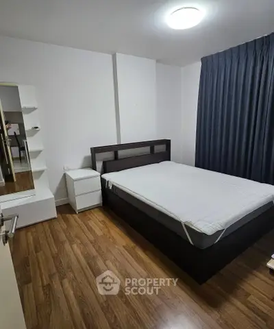 Cozy bedroom with wooden flooring and modern furniture