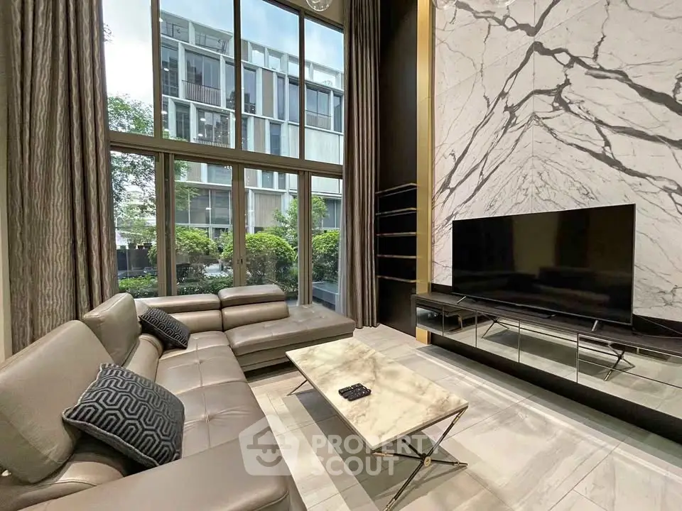 Luxurious living room with high ceilings and modern marble accents