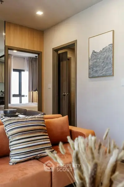 Modern living room with stylish decor and cozy orange sofa