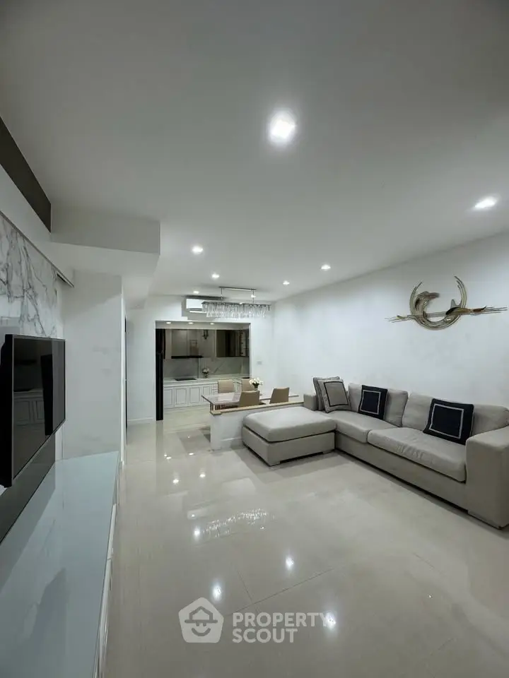 Spacious modern living room with elegant decor and open kitchen layout