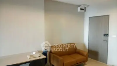 Modern living room with brown sofa and dining table in a cozy apartment.