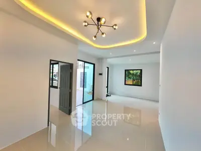 Spacious modern living room with elegant lighting and glossy tiled floors