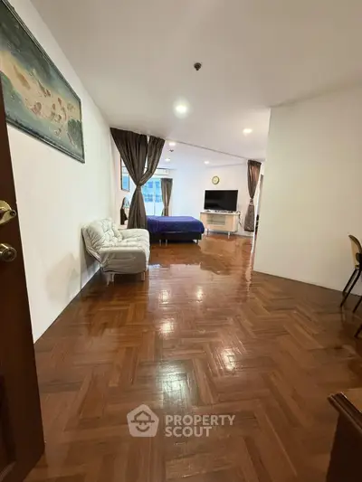 Spacious studio apartment with wooden flooring and modern decor