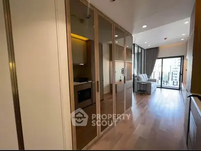 Spacious modern living room with floor-to-ceiling windows and wooden flooring