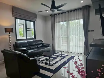 Stylish modern living room with black leather sofas and chic decor