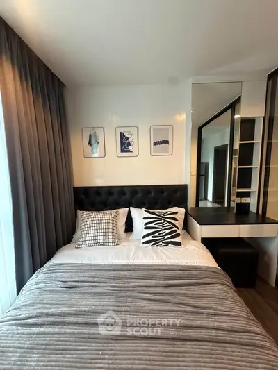 Modern bedroom with stylish decor and cozy ambiance, featuring a comfortable bed and elegant furnishings.