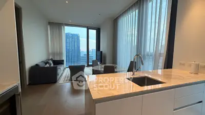 Luxurious open-plan living room with stunning city view and modern kitchen.
