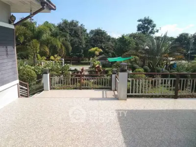Spacious garden view from a sunny patio in a serene residential area.