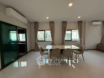 Spacious modern living room with elegant dining area and large windows