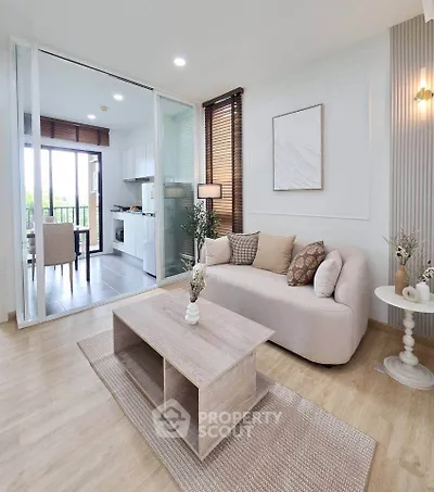 Modern living room with cozy sofa and open kitchen layout