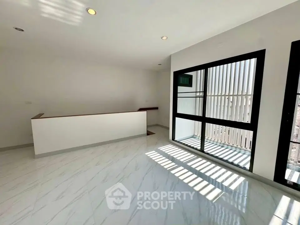Spacious modern living room with large windows and sleek flooring