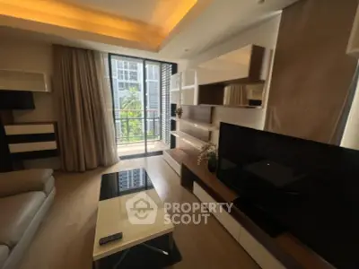 Modern living room with stylish furniture and balcony view in a high-rise apartment.