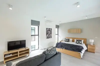 Spacious modern bedroom with stylish decor and natural light