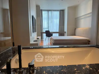 Luxurious modern bedroom with sleek design and city view, featuring a stylish bathtub and elegant furnishings.
