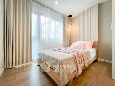 Cozy bedroom with modern decor and large window for natural light
