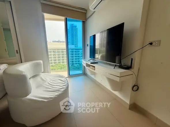 Modern living room with sleek TV setup and city view from window
