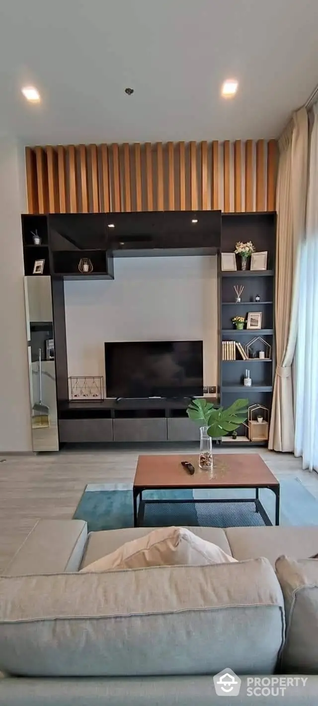 Chic modern living room with elegant wooden wall paneling and sleek entertainment unit, complemented by cozy furnishings and tasteful decor.