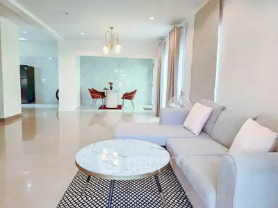 Spacious modern living room with elegant decor and open dining area