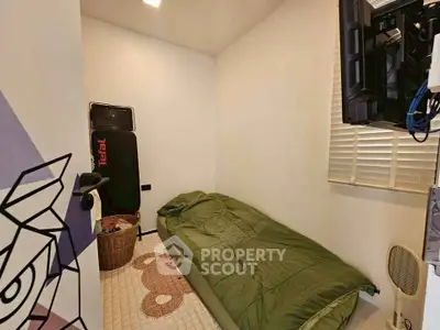Cozy small bedroom with minimalist decor and wall-mounted TV, perfect for compact living spaces.