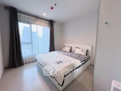 Modern bedroom with large window and stylish decor in urban apartment