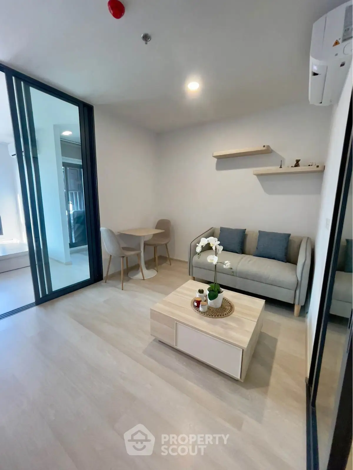 Modern living room with cozy sofa and dining area in open layout apartment.