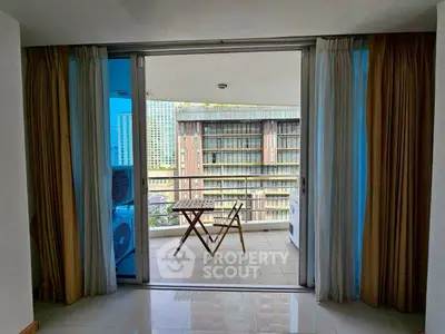 Spacious balcony with city view, perfect for relaxation and outdoor dining.