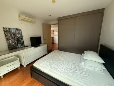 Spacious bedroom with modern furniture and air conditioning in a stylish apartment.
