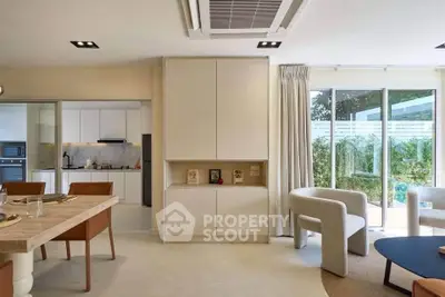 Modern open-plan living room with elegant dining area and garden view