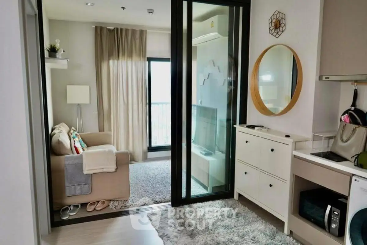 Cozy living room with modern decor and natural light in a stylish apartment.