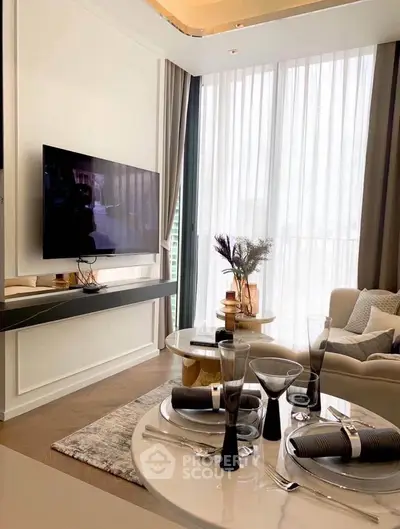 Luxurious living room with elegant decor, large TV, and floor-to-ceiling windows offering natural light.