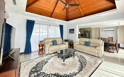 Spacious living room with vaulted wooden ceiling and elegant decor