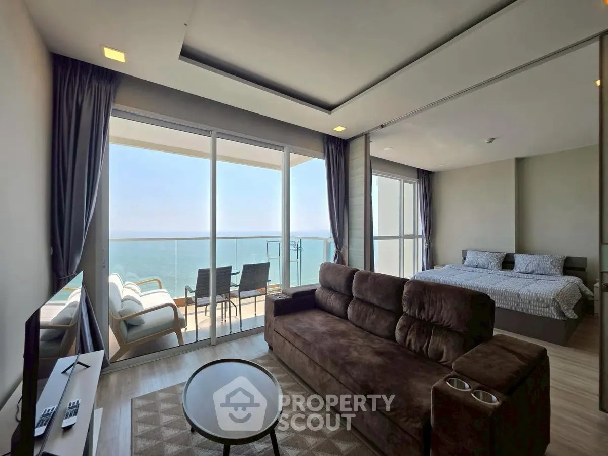 Luxurious beachfront living room with stunning ocean view and cozy bedroom