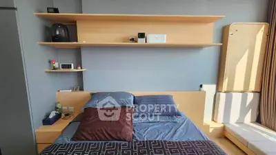 Modern bedroom with sleek wooden shelves and cozy bedding in a stylish apartment.
